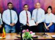 Hayleys Fabric Managing Director Rohan Goonetilleke (third from right) exchanging the MOU with University of Sri Jayawardenapura Vice Chancellor Prof. Pathmalal M. Manage (third from left) in the presence of teams from Hayleys Fabric and University of Sri Jayawardenapura.
